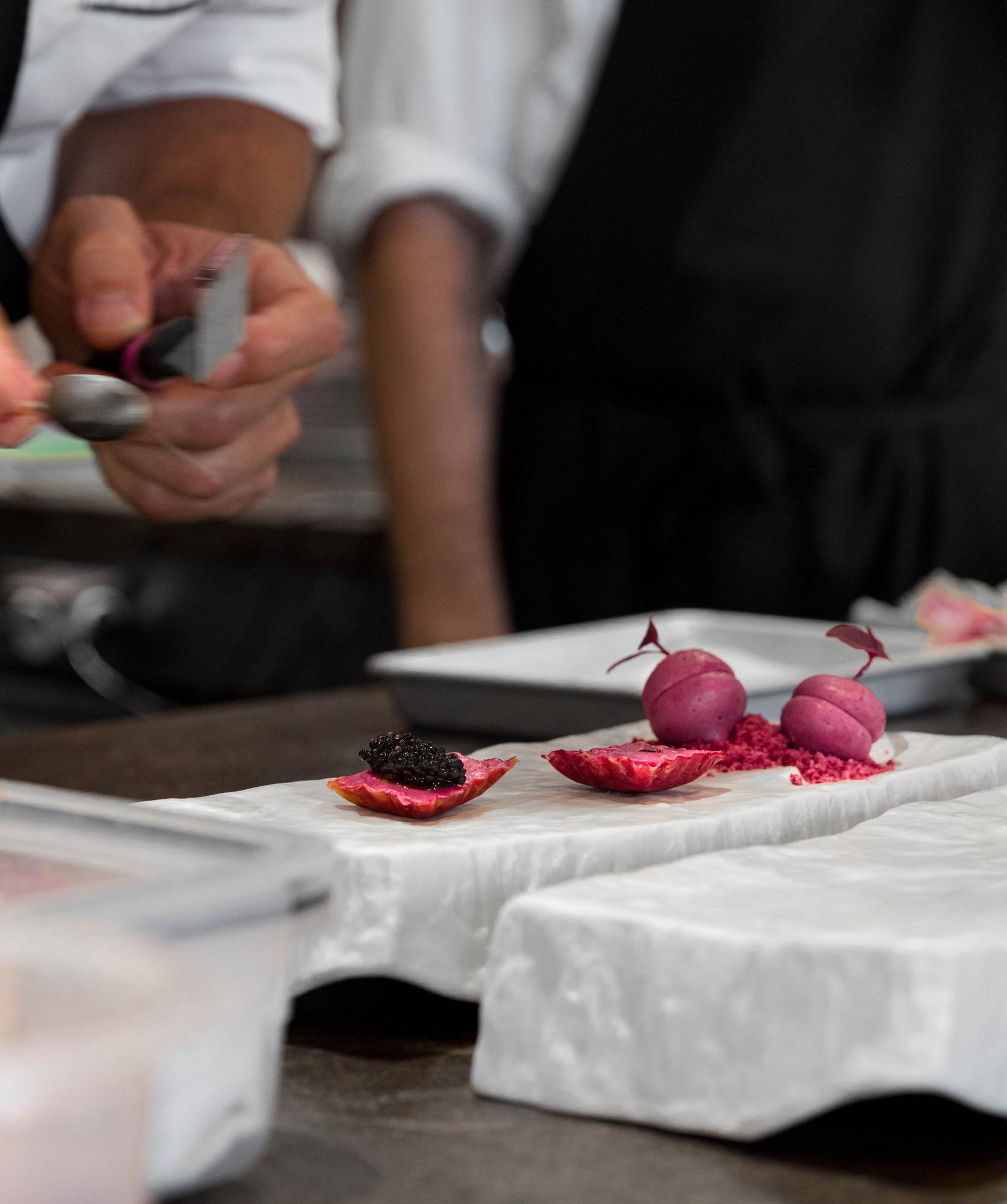 Students plating in a compact atelier kitchen
